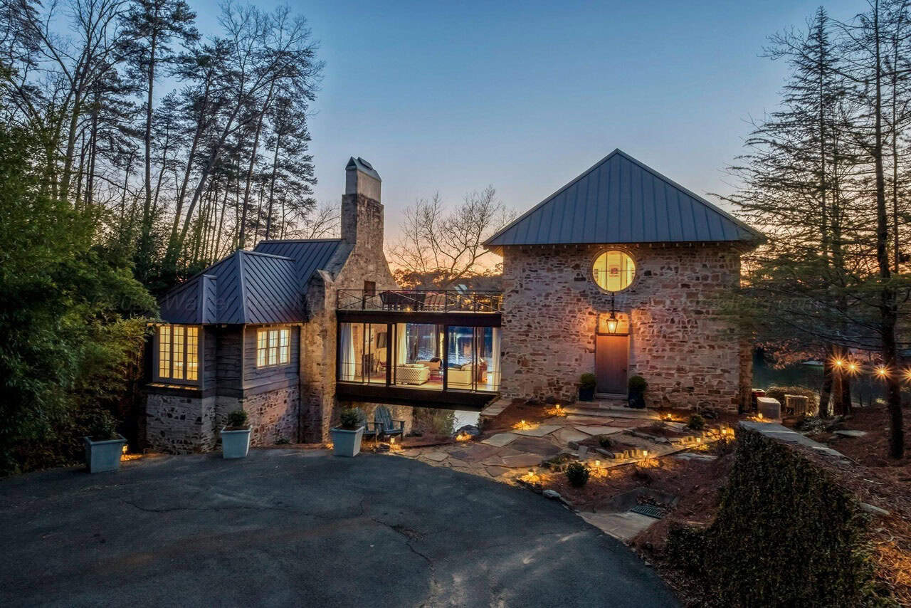 stone lake house exterior at dusk
