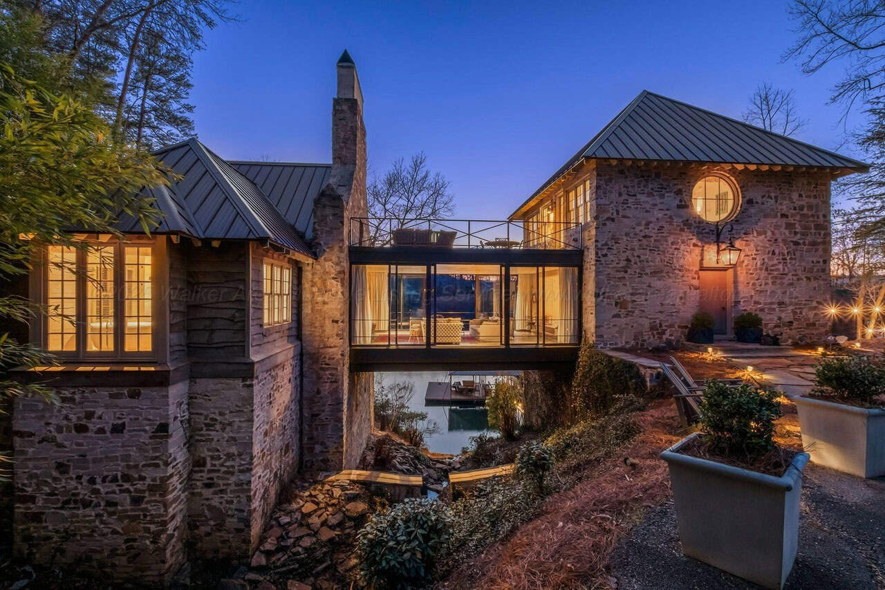 stone lake house exterior at dusk
