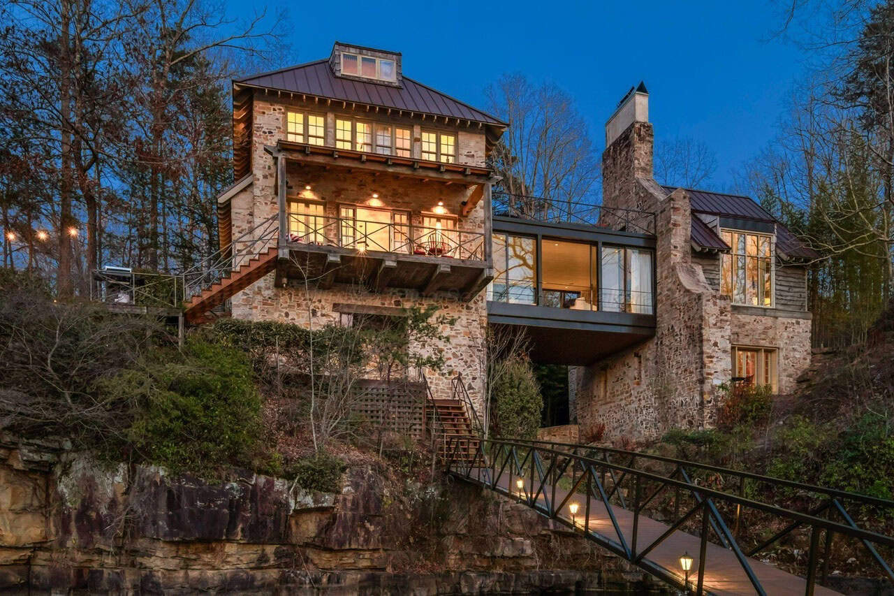 stone lake house exterior at dusk