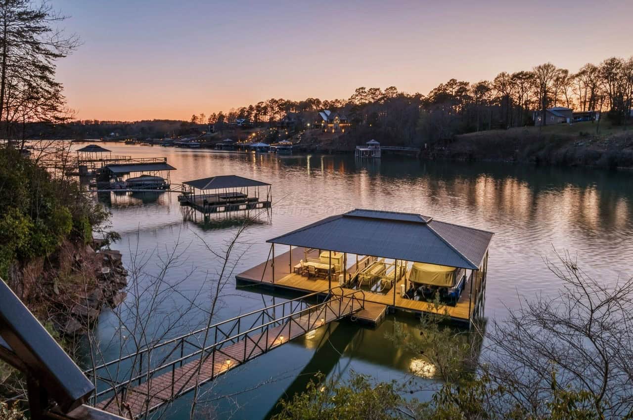 stone lake house exterior with a boat dock