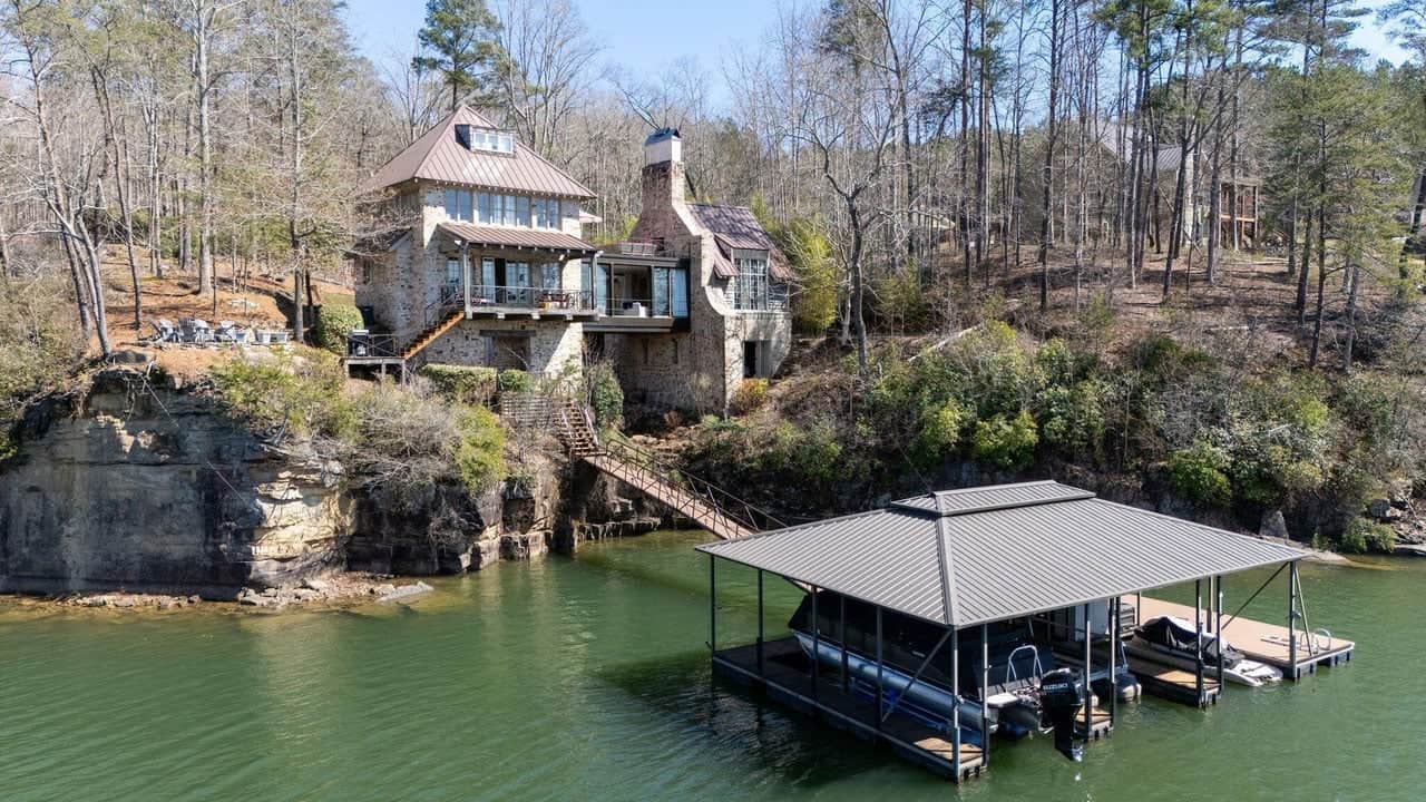 stone lake house with boat dock