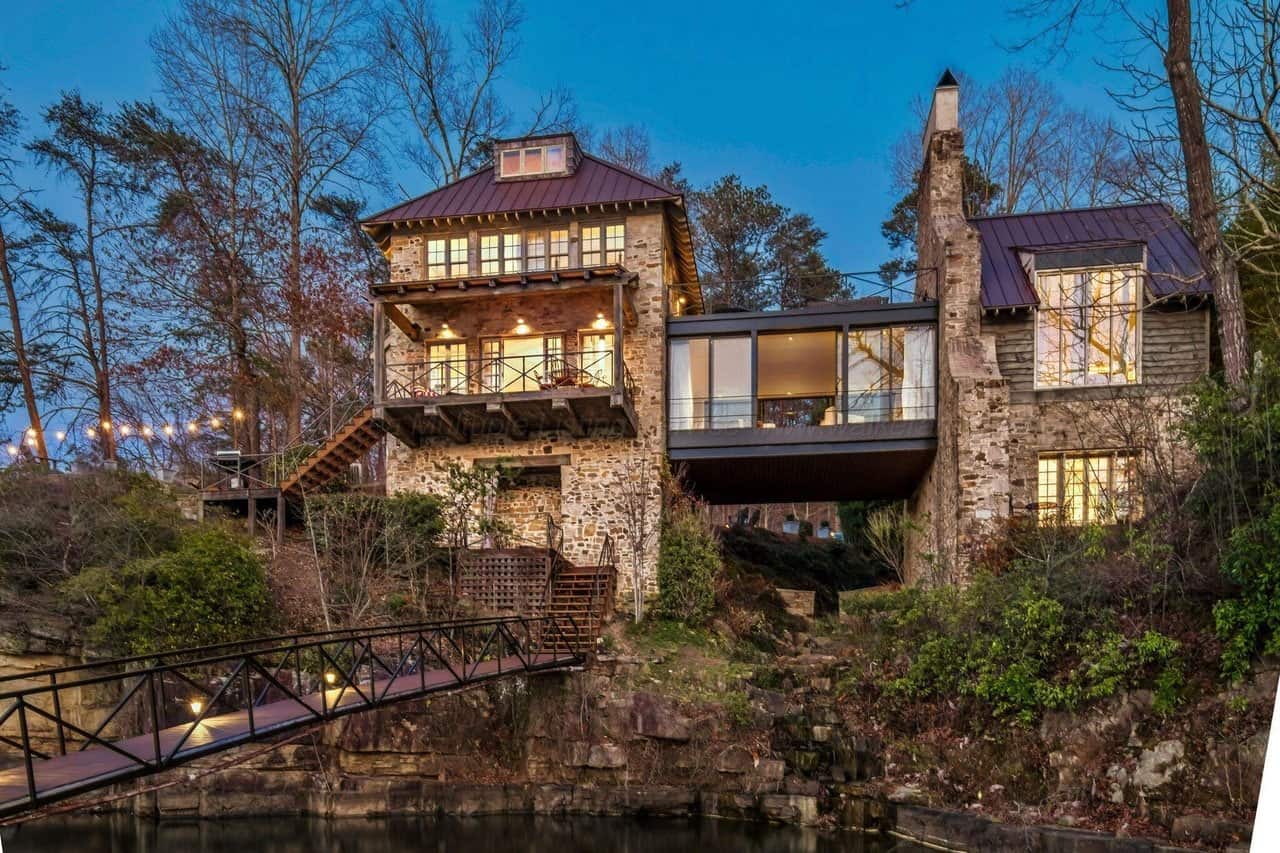 stone lake house exterior at dusk