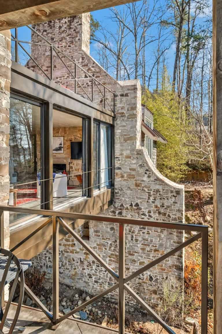 Step inside this picturesque Alabama lake house with a timeless stone