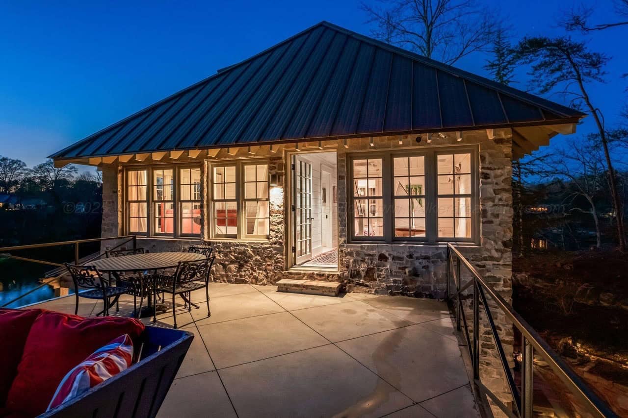 stone lake house exterior at dusk