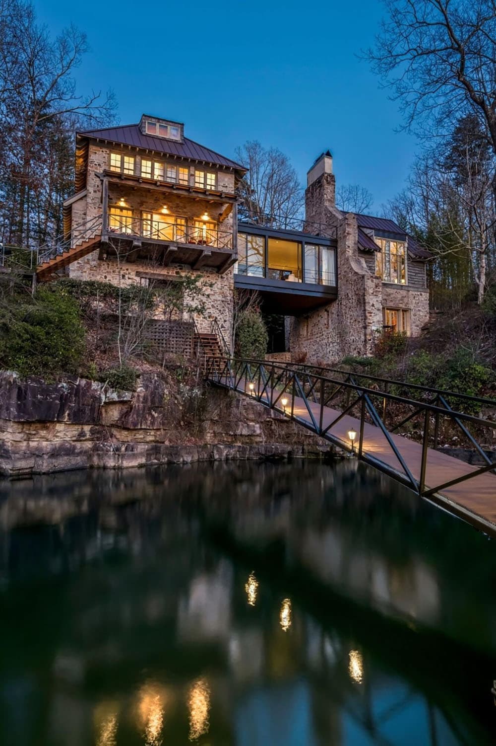 stone lake house exterior at dusk