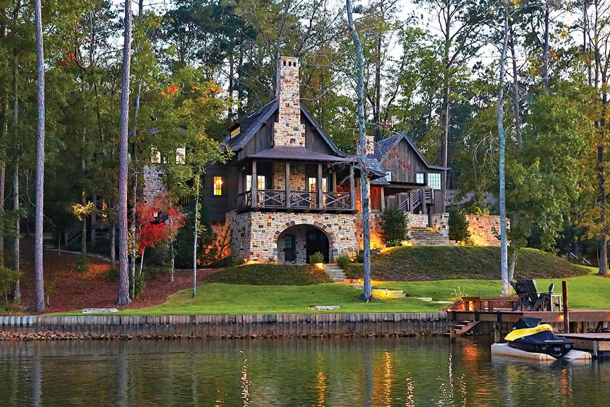 stone lake house exterior at dusk