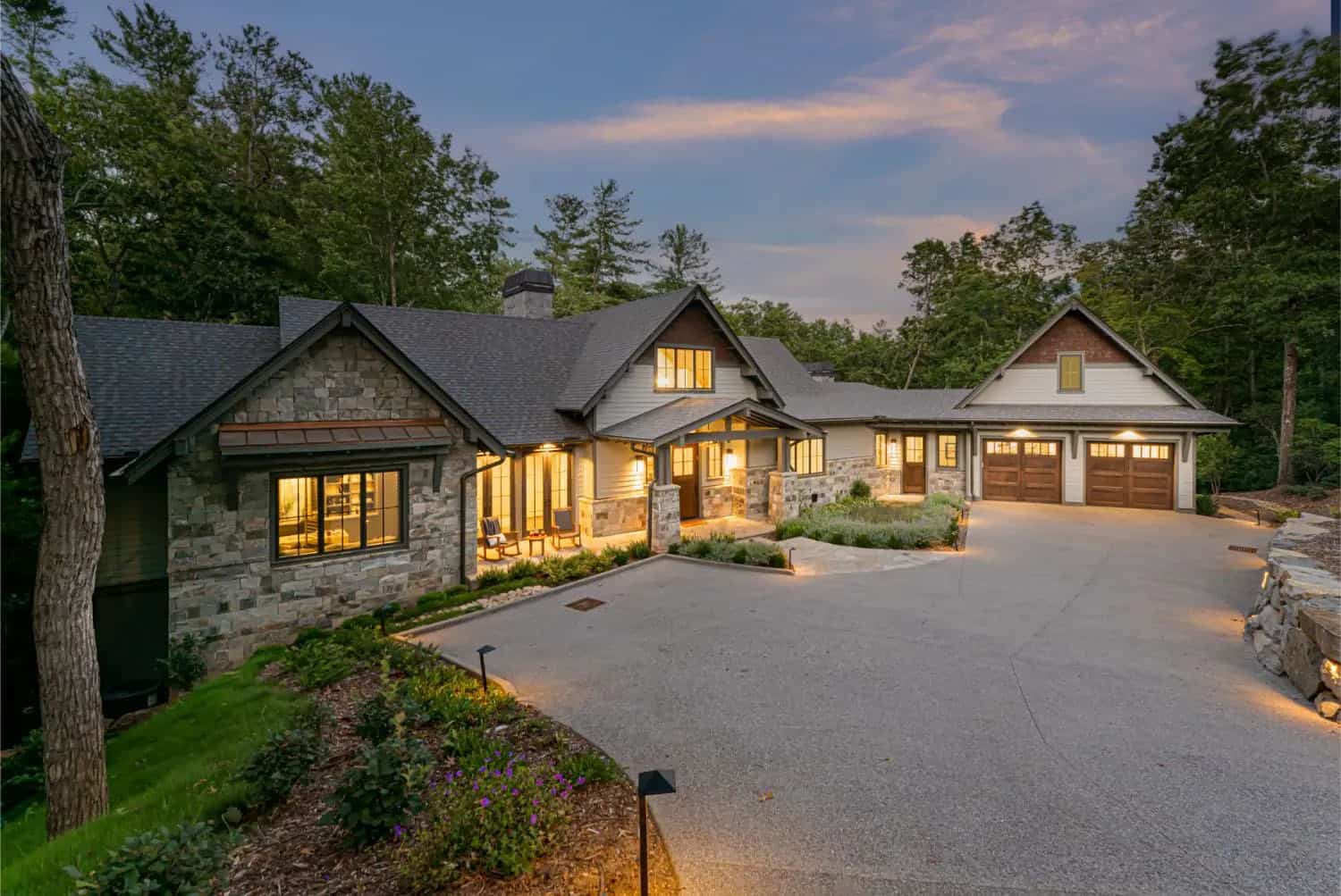 transitional style mountain home exterior at dusk