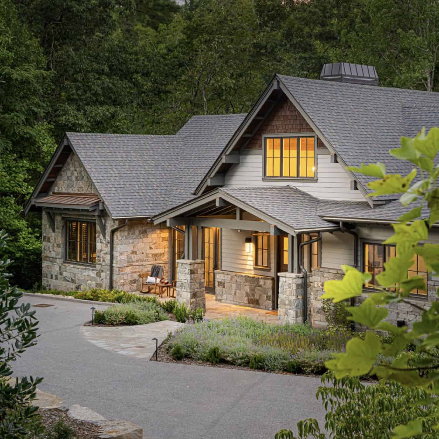 transitional style mountain home exterior at dusk