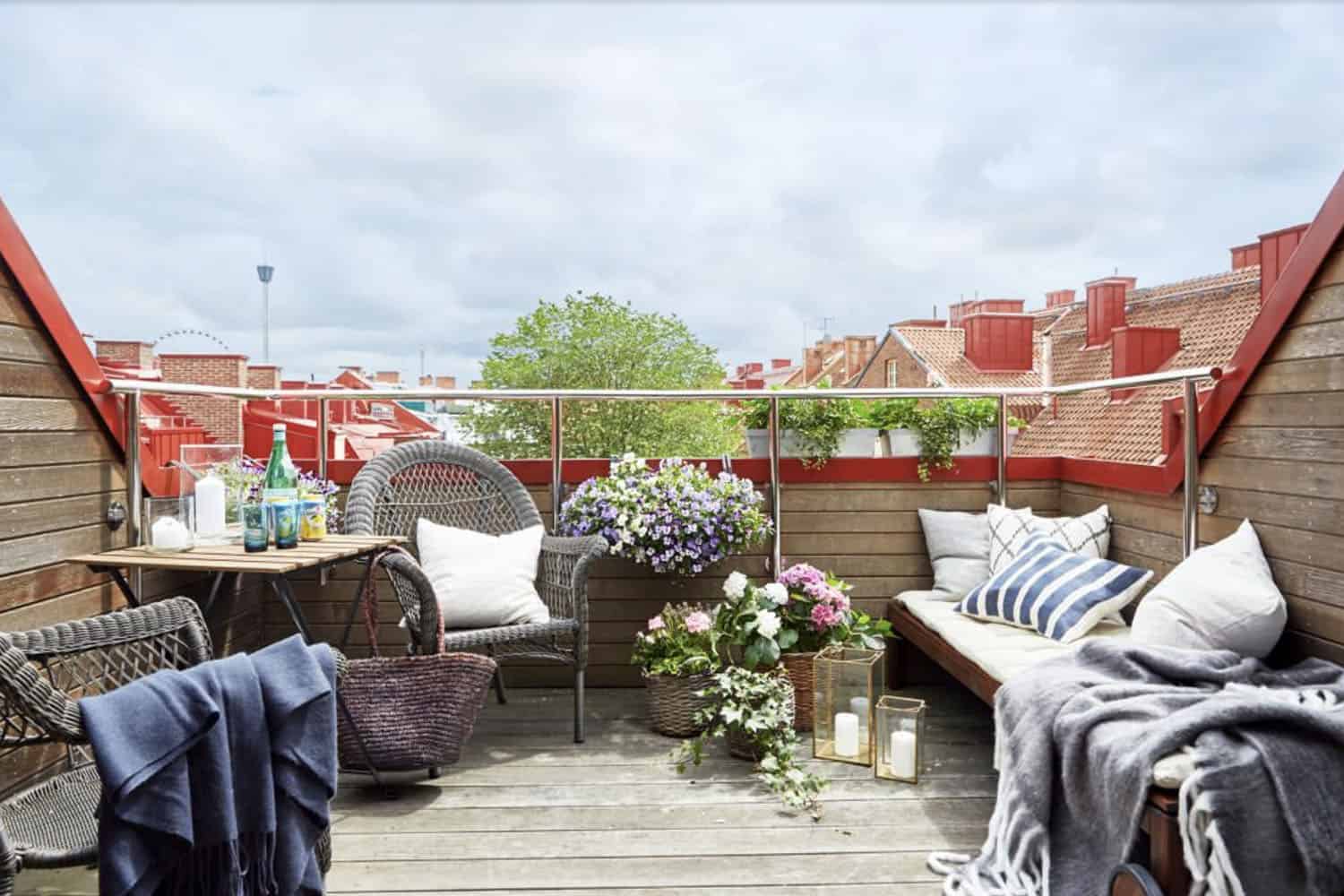 scandinavian style deck with outdoor furniture and potted plants