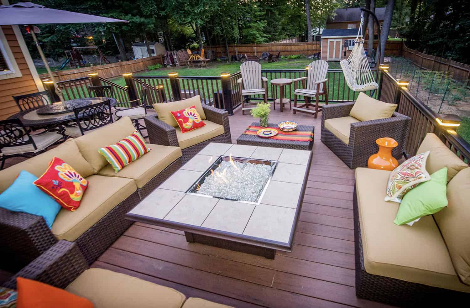 backyard deck with outdoor furniture and a fire table