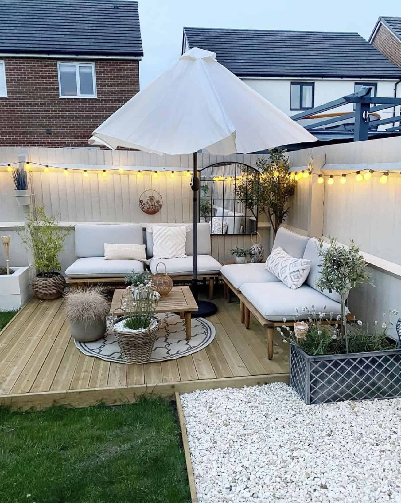 backyard deck with outdoor furnishings, an umbrella and a fence