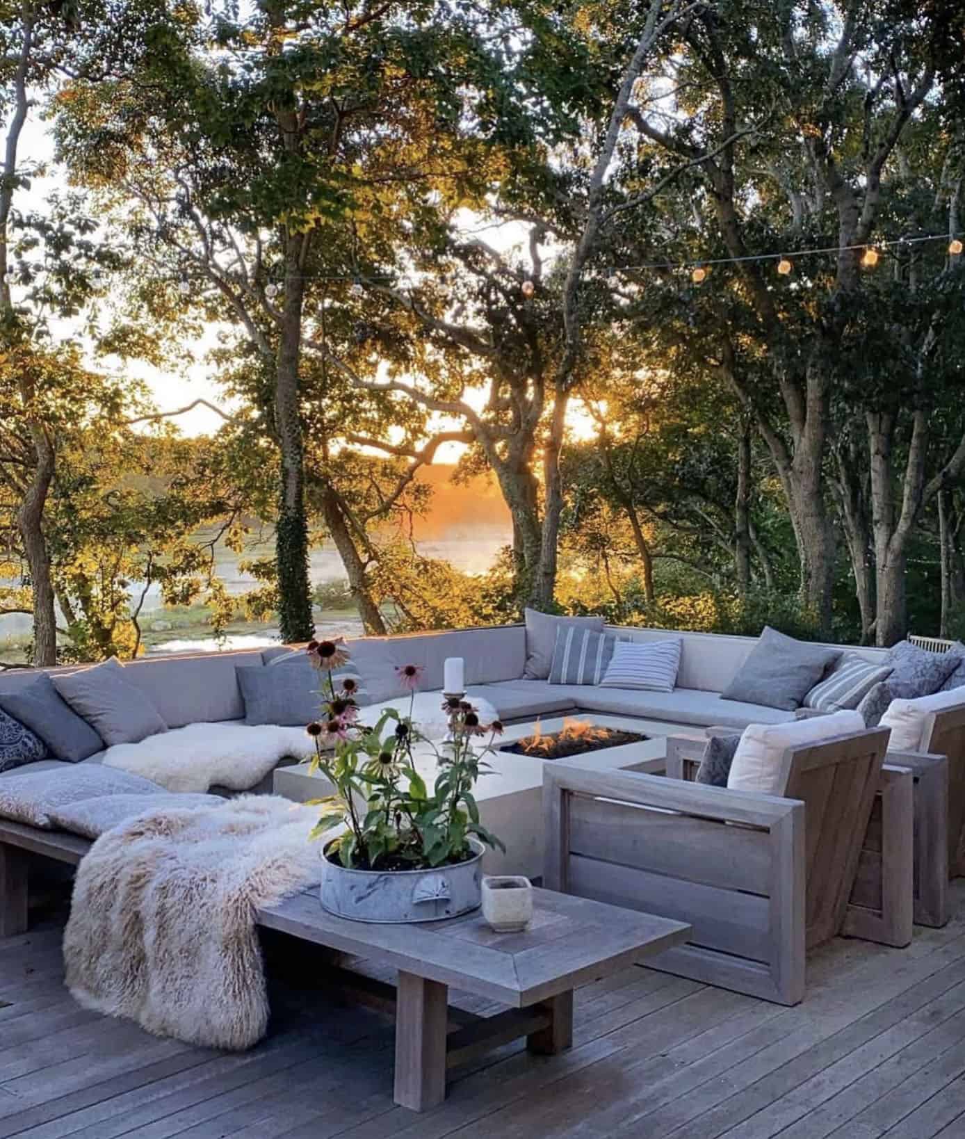 backyard deck with a built-in sectional and fire pit