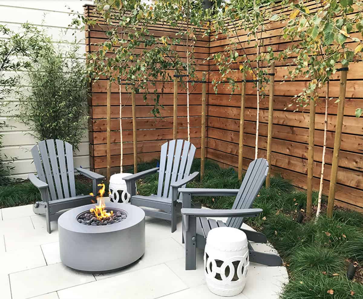 contemporary backyard patio with a fire pit and adirondack chairs
