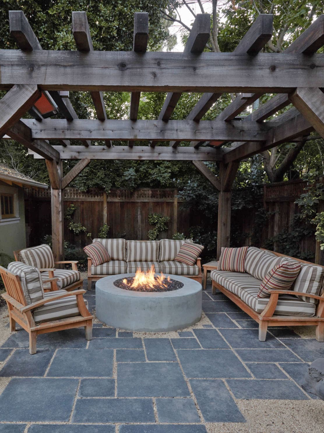 arbored lounge area with a fire pit
