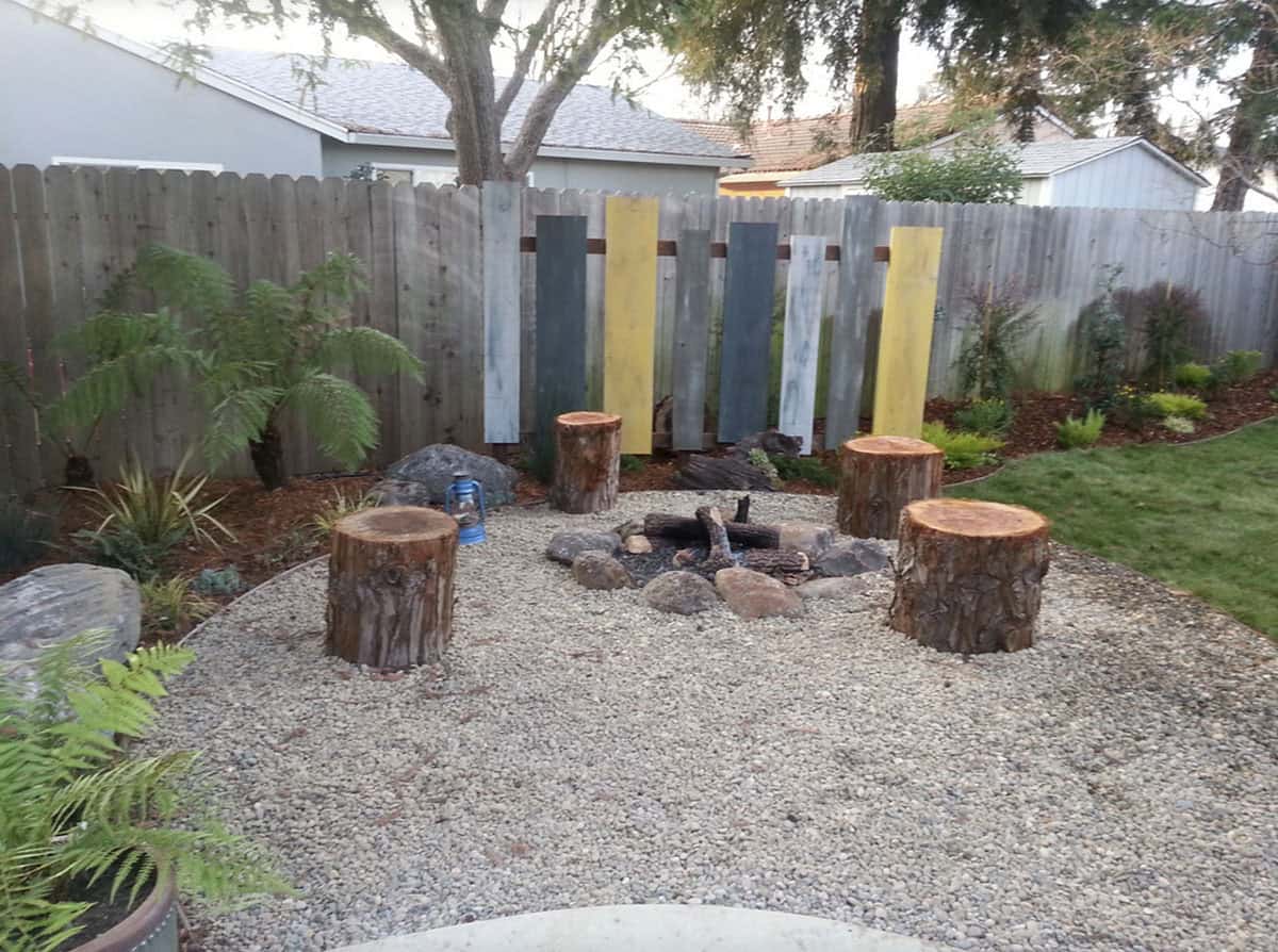 small backyard fire pit with log seating