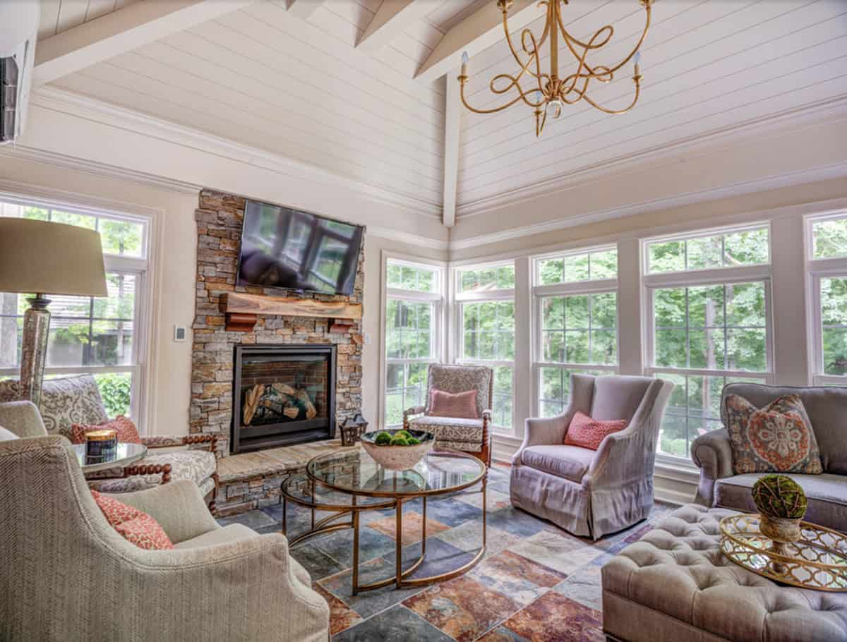traditional style four-season sunroom with a fireplace