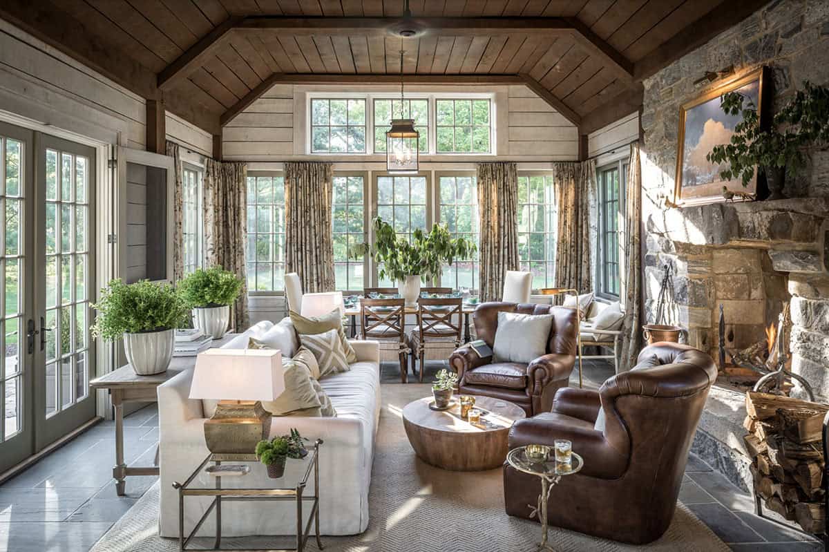 farmhouse style sunroom with a stone fireplace