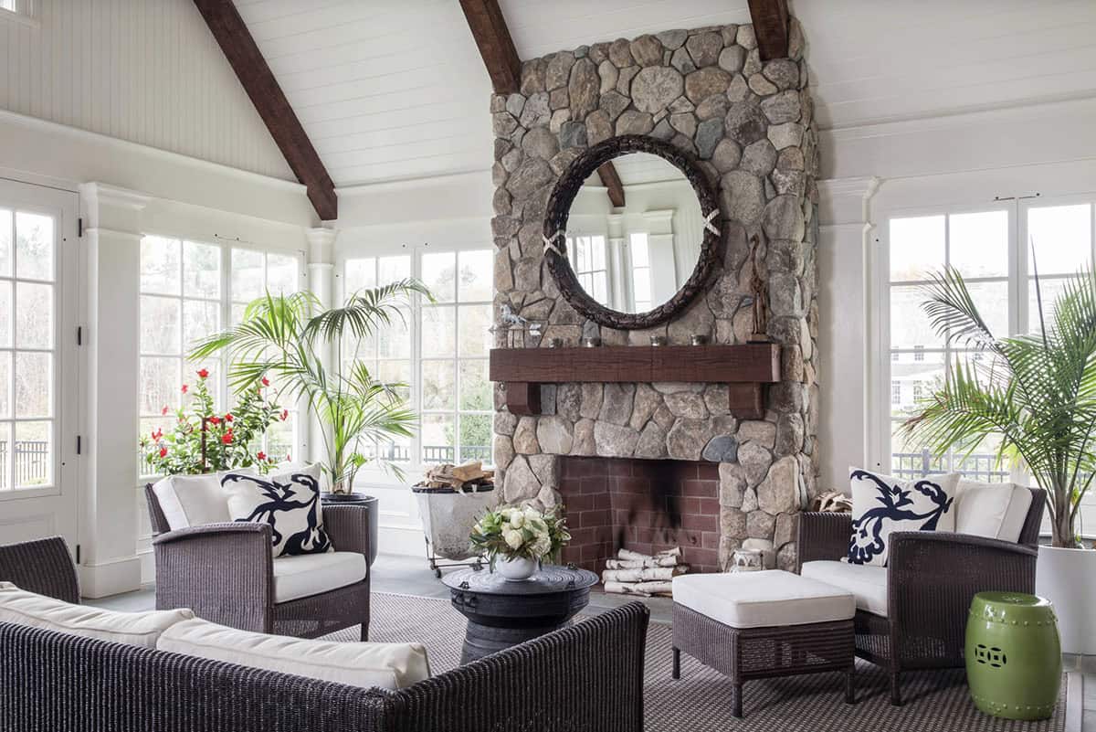 traditional sunroom with a fireplace and mirror