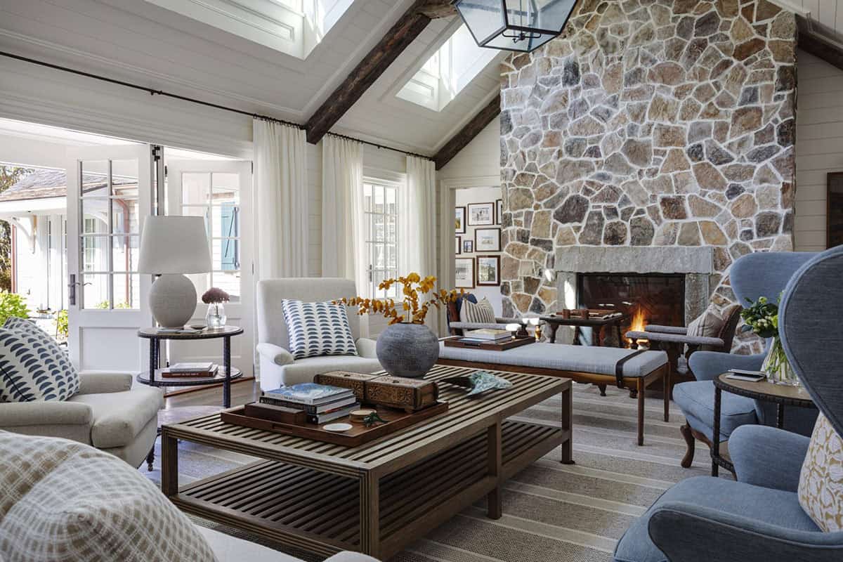 modern living room with a stone fireplace and skylights