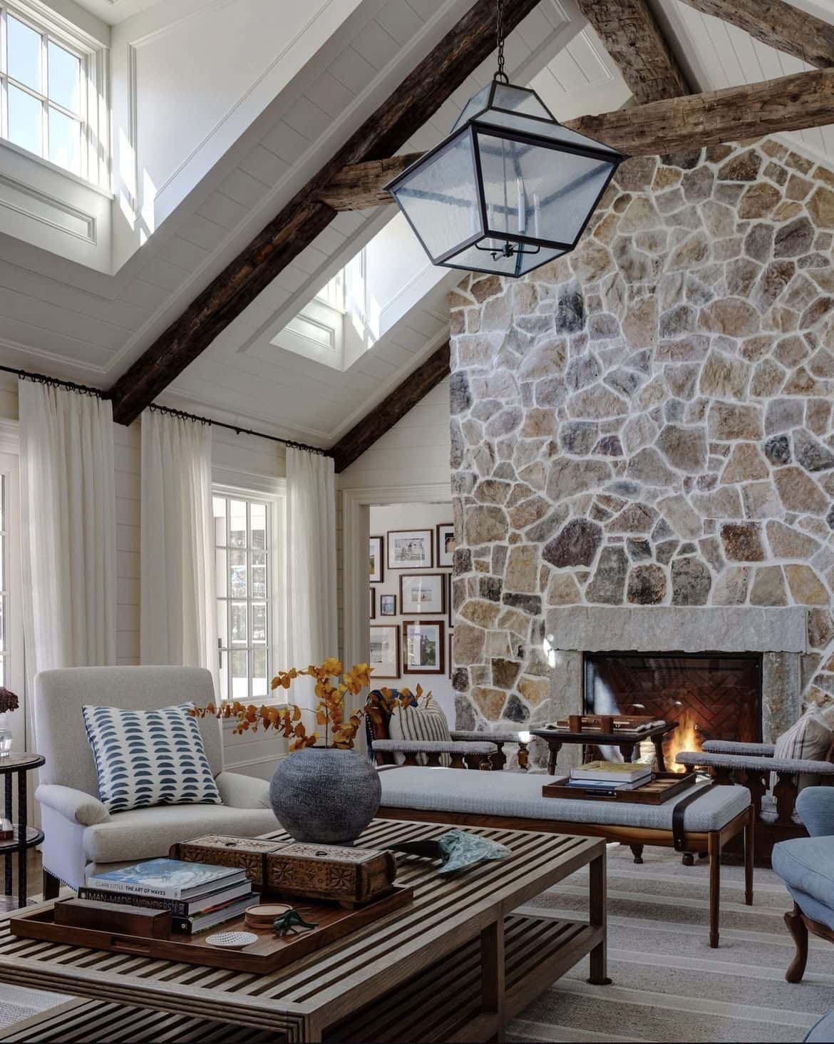 modern living room with a stone fireplace and skylights