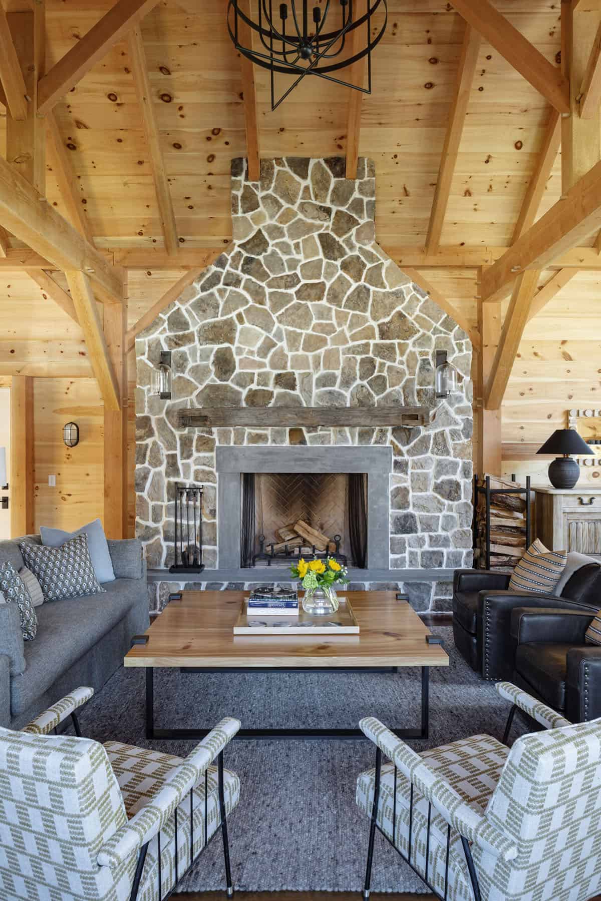 modern rustic carriage house living room with a stone fireplace