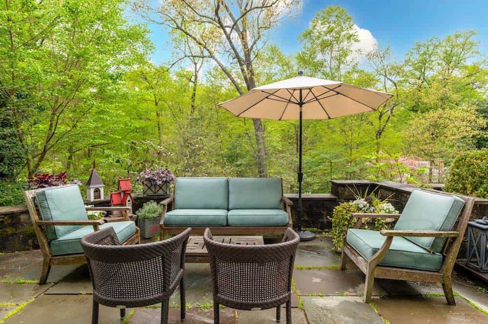 stone house exterior backyard patio with outdoor furniture