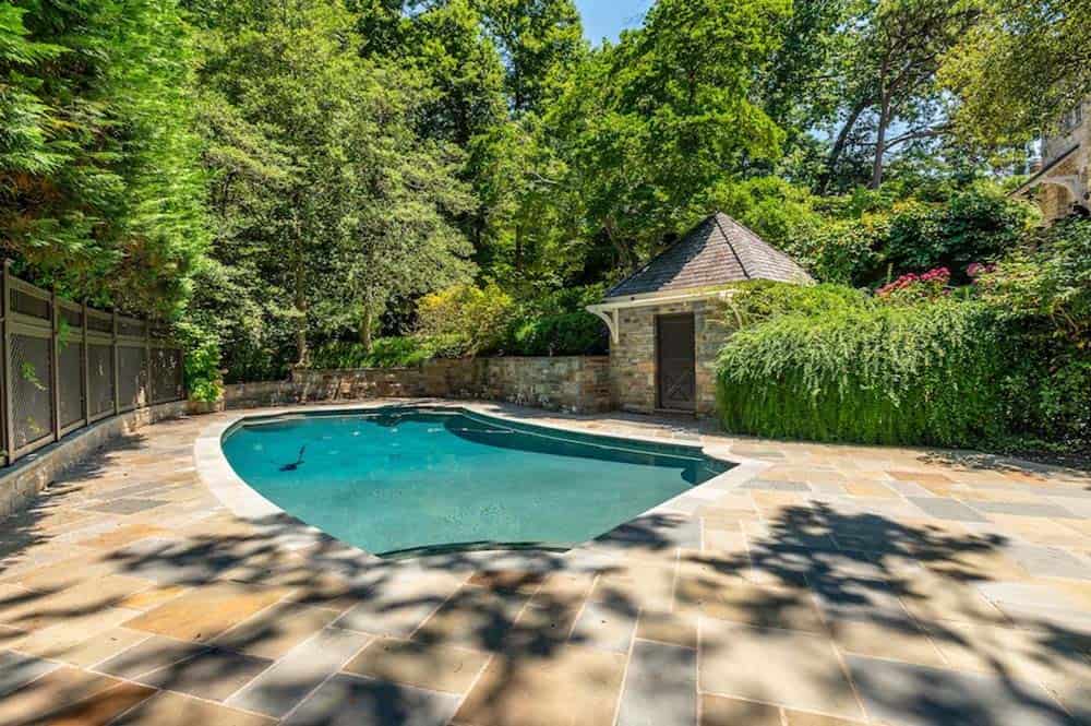 stone house exterior backyard with pool