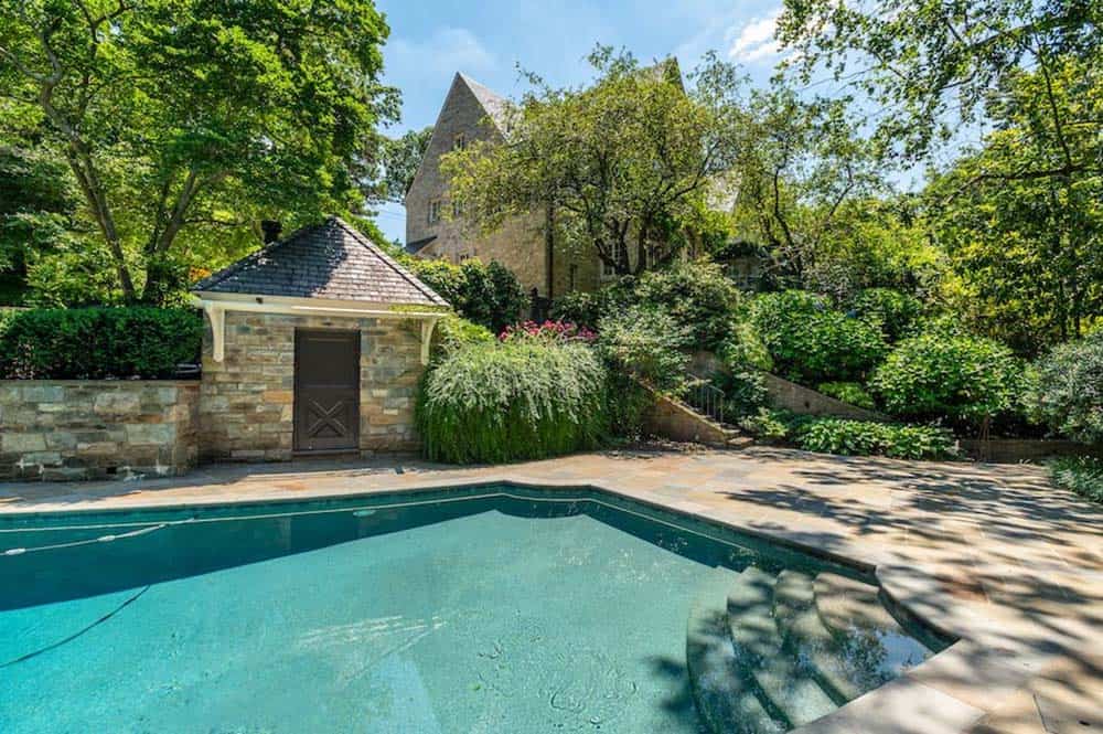 stone house exterior backyard with pool