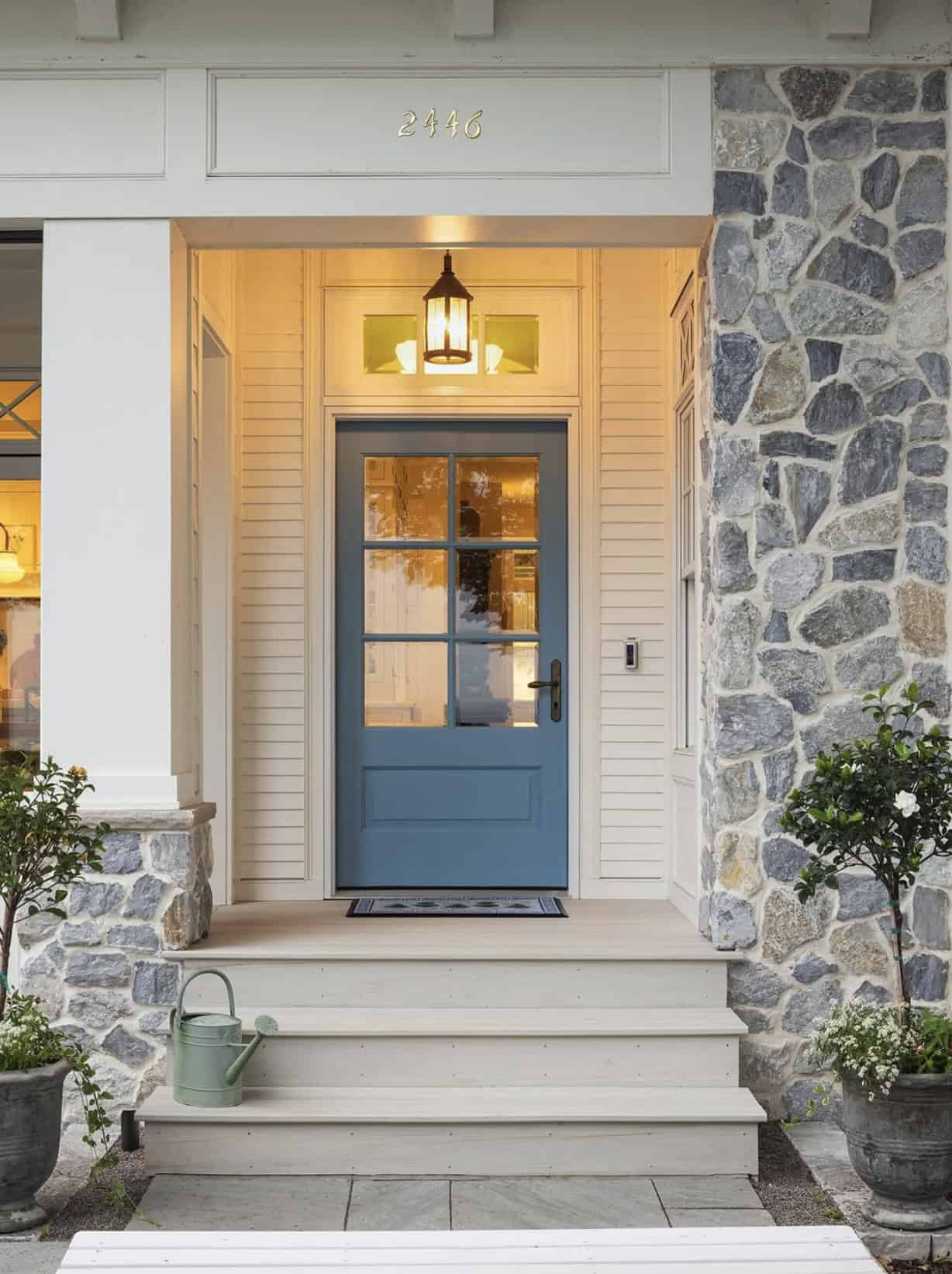 coastal cottage-style home exterior entry with a blue door