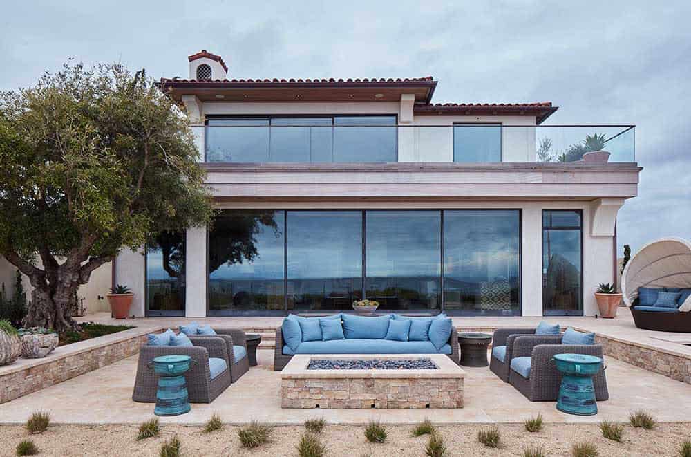 coastal home exterior with a large patio and fire pit