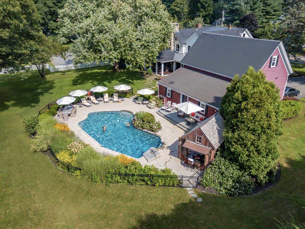 farmhouse style home exterior with a pool