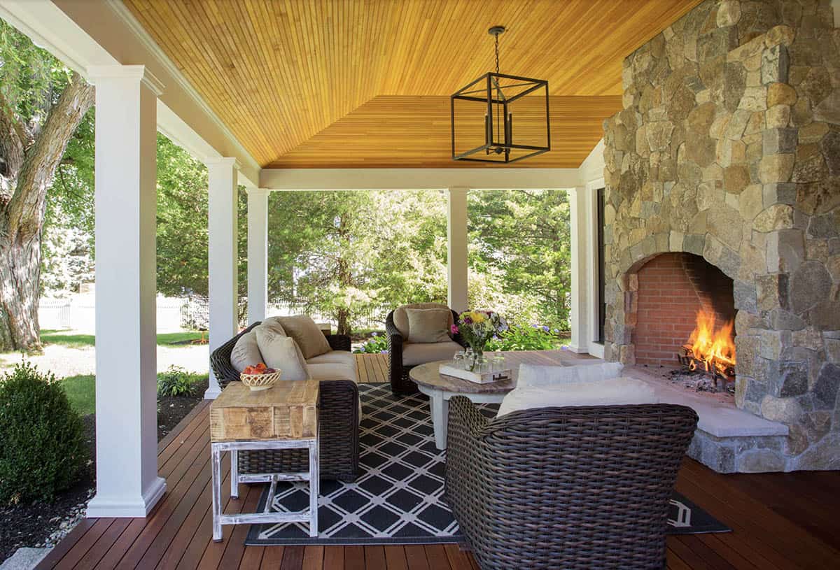 farmhouse style home exterior with a covered porch and fireplace