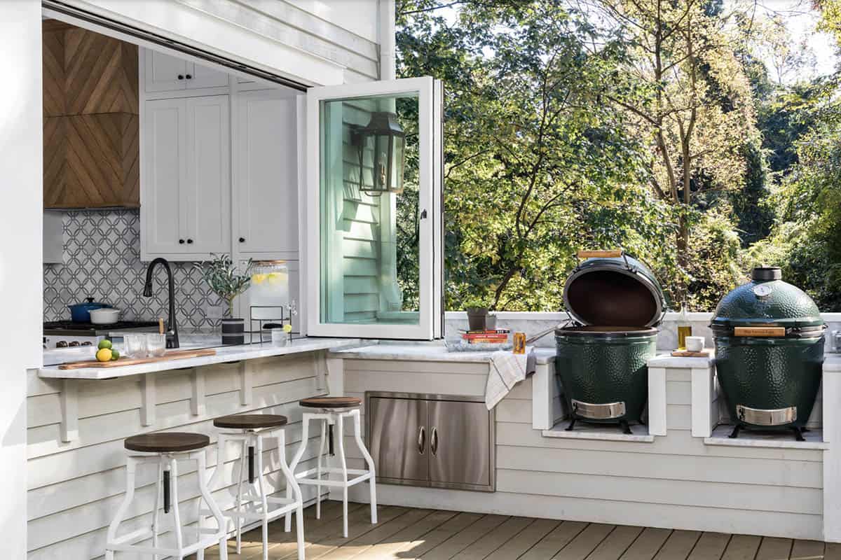 transitional style deck with a pass through window and grilling station