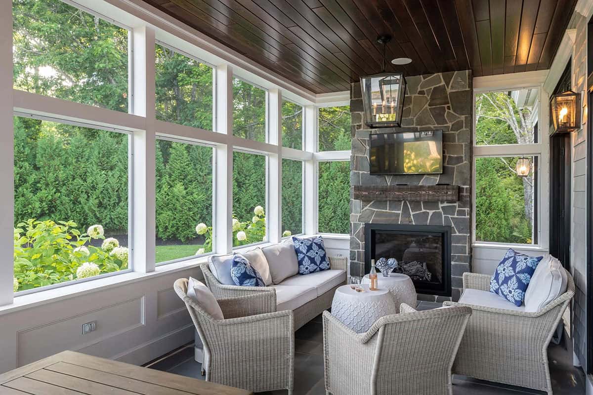 beach style screened porch with a fireplace