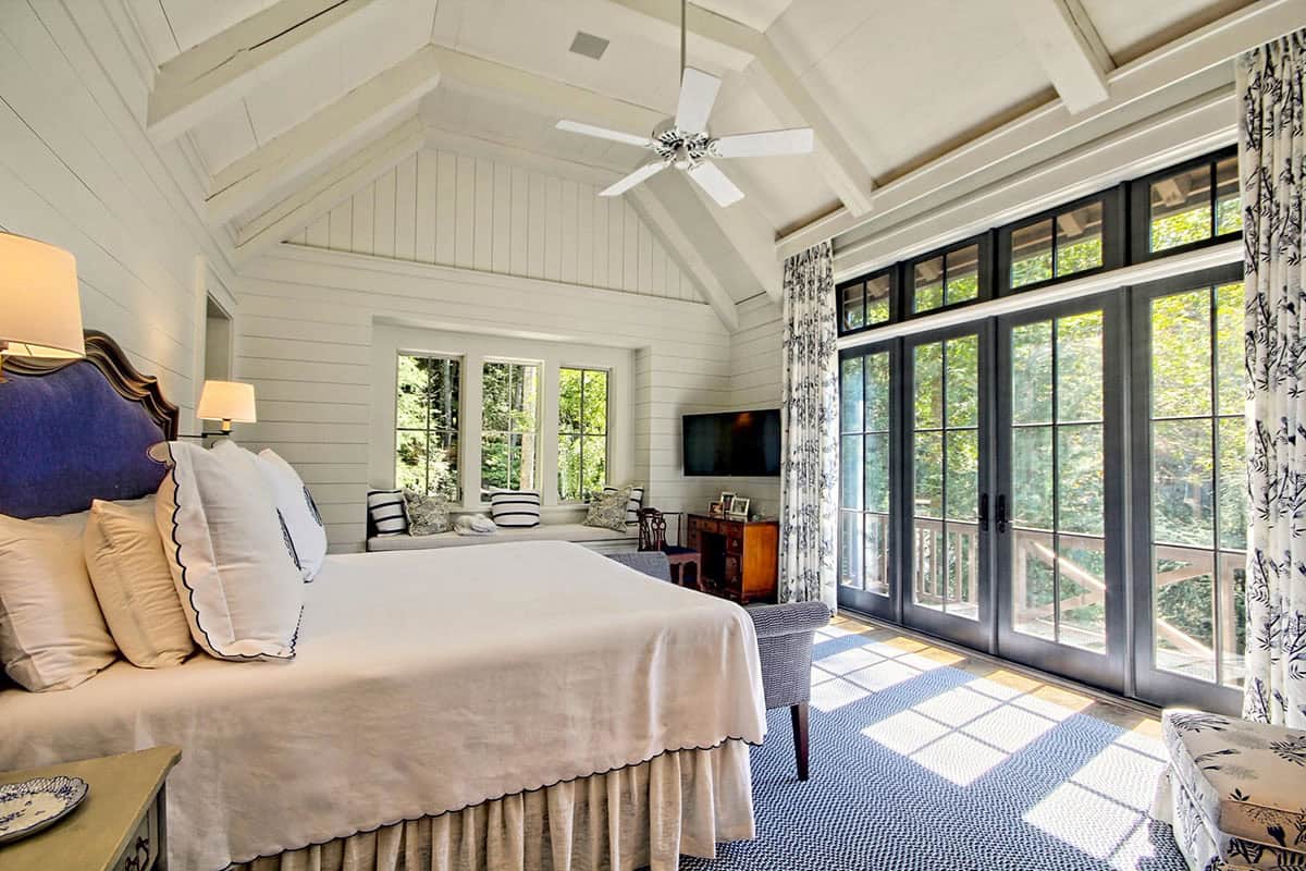 farmhouse style bedroom with a vaulted ceiling