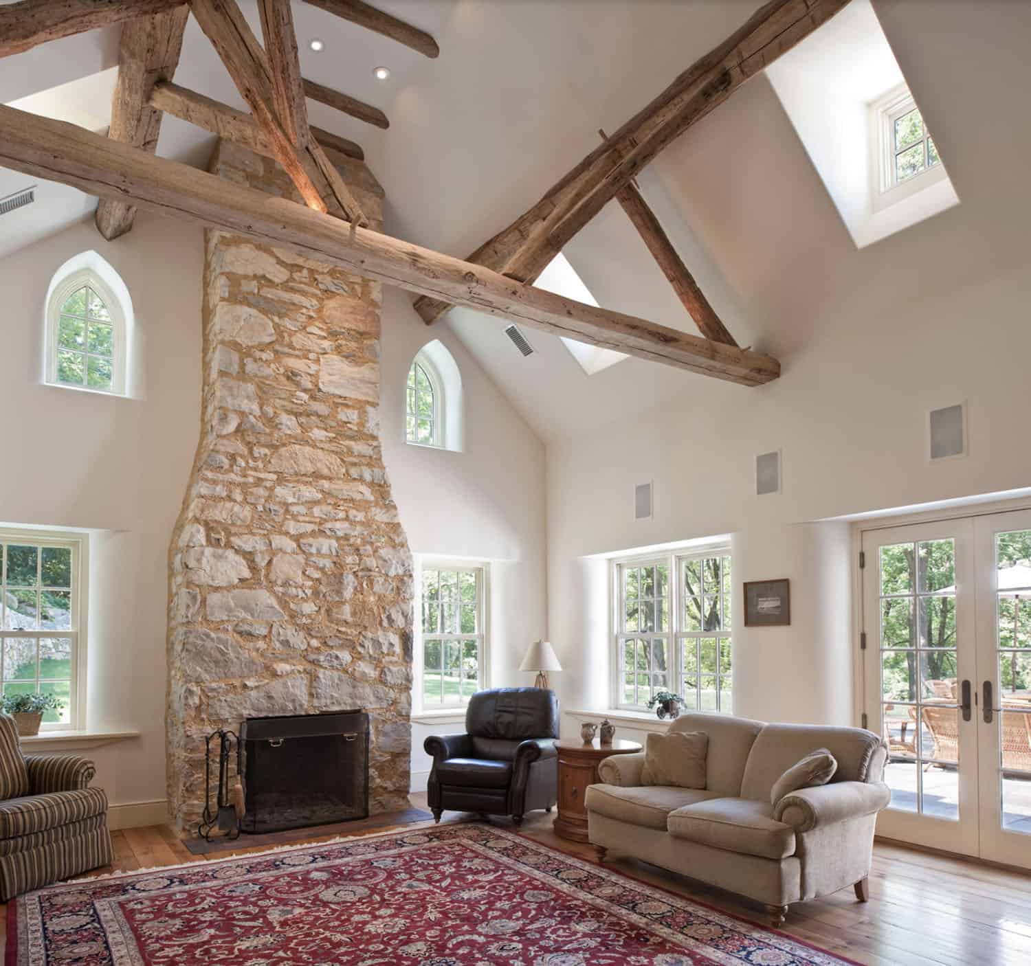 farmhouse style living room with a stone fireplace