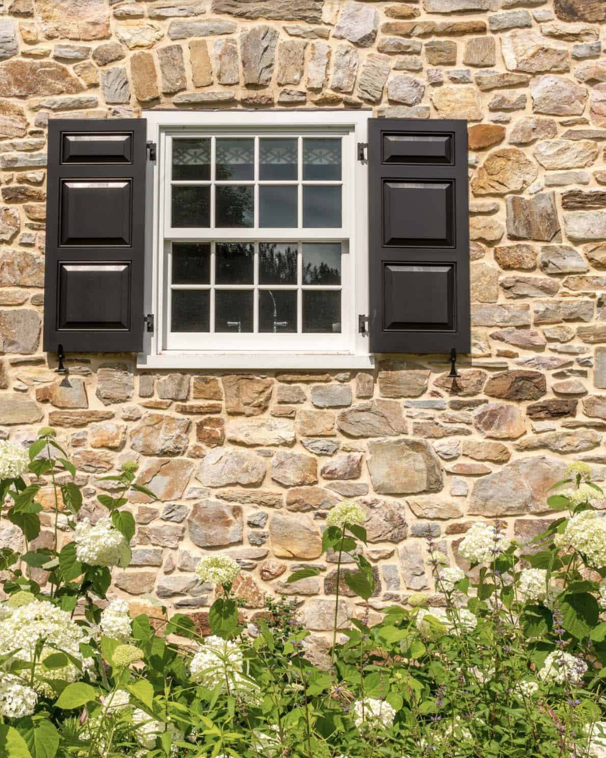 historic farmhouse home exterior with window shutters