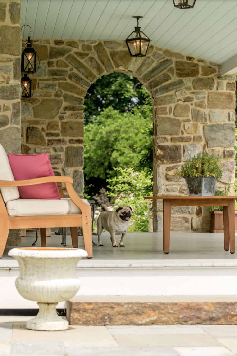 historic farmhouse home exterior with a porch and outdoor furniture