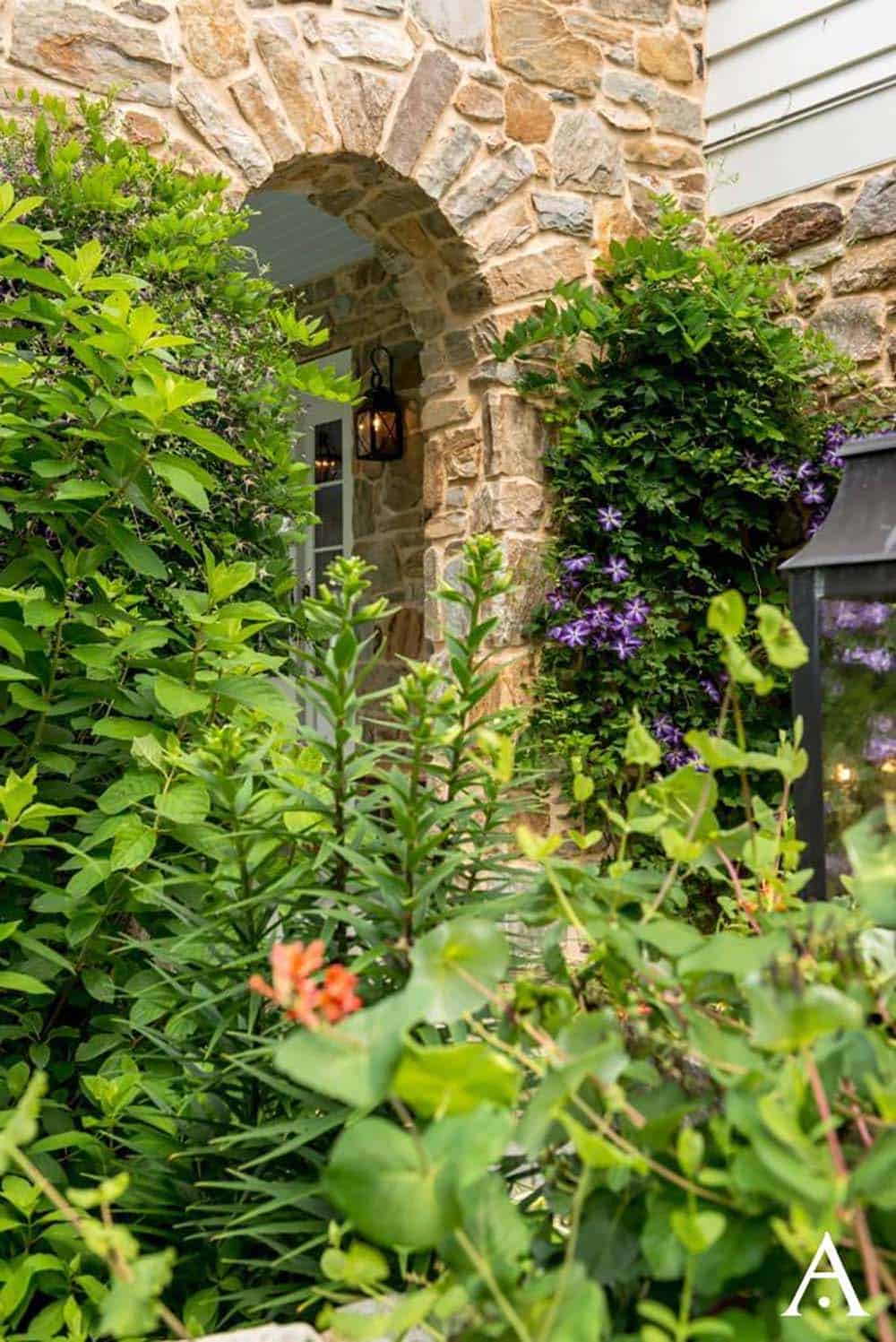 historic farmhouse home exterior with a garden