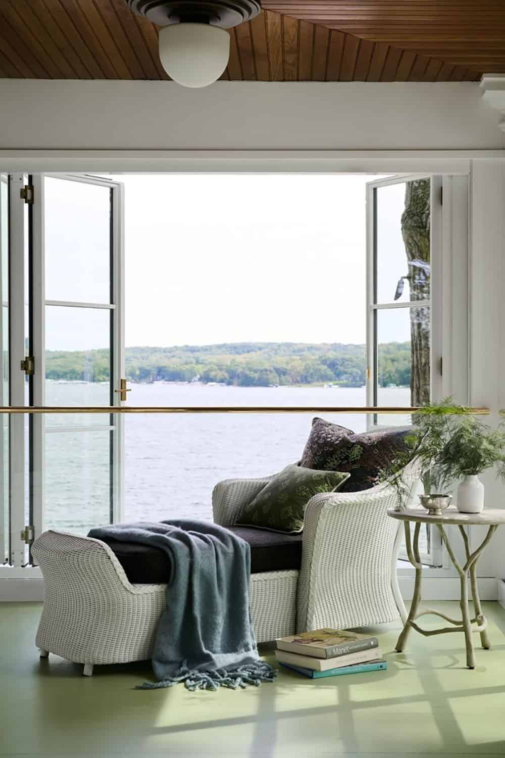 contemporary sunroom with large windows and a lake view