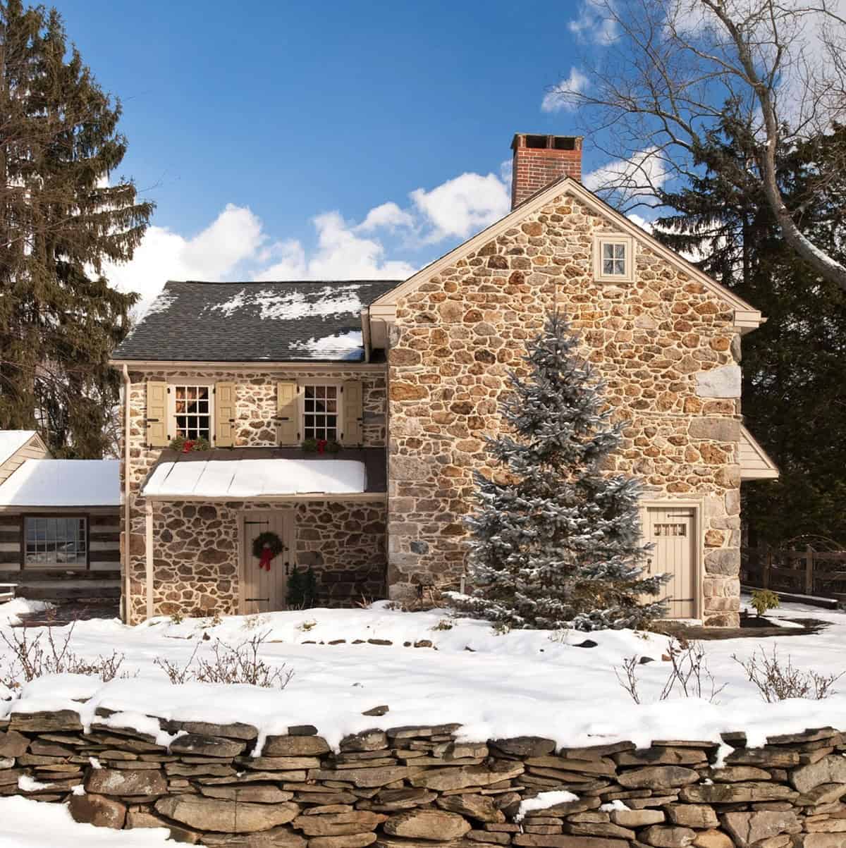 stone farmhouse exterior with snow