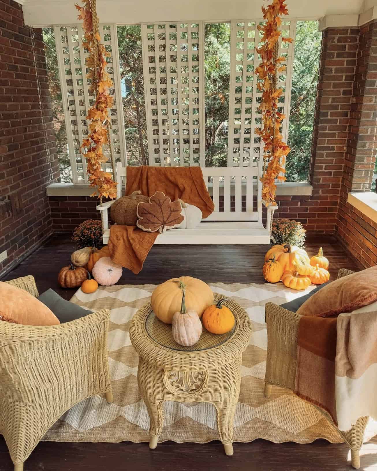 fall decorated back porch with a hanging swing
