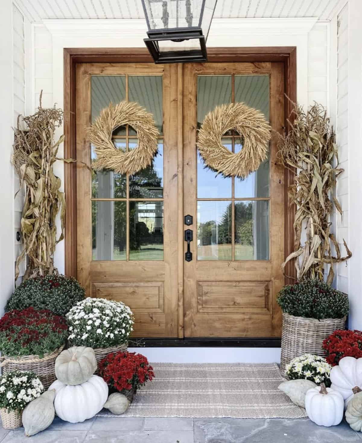 fall decorated front porch with wreaths and mums