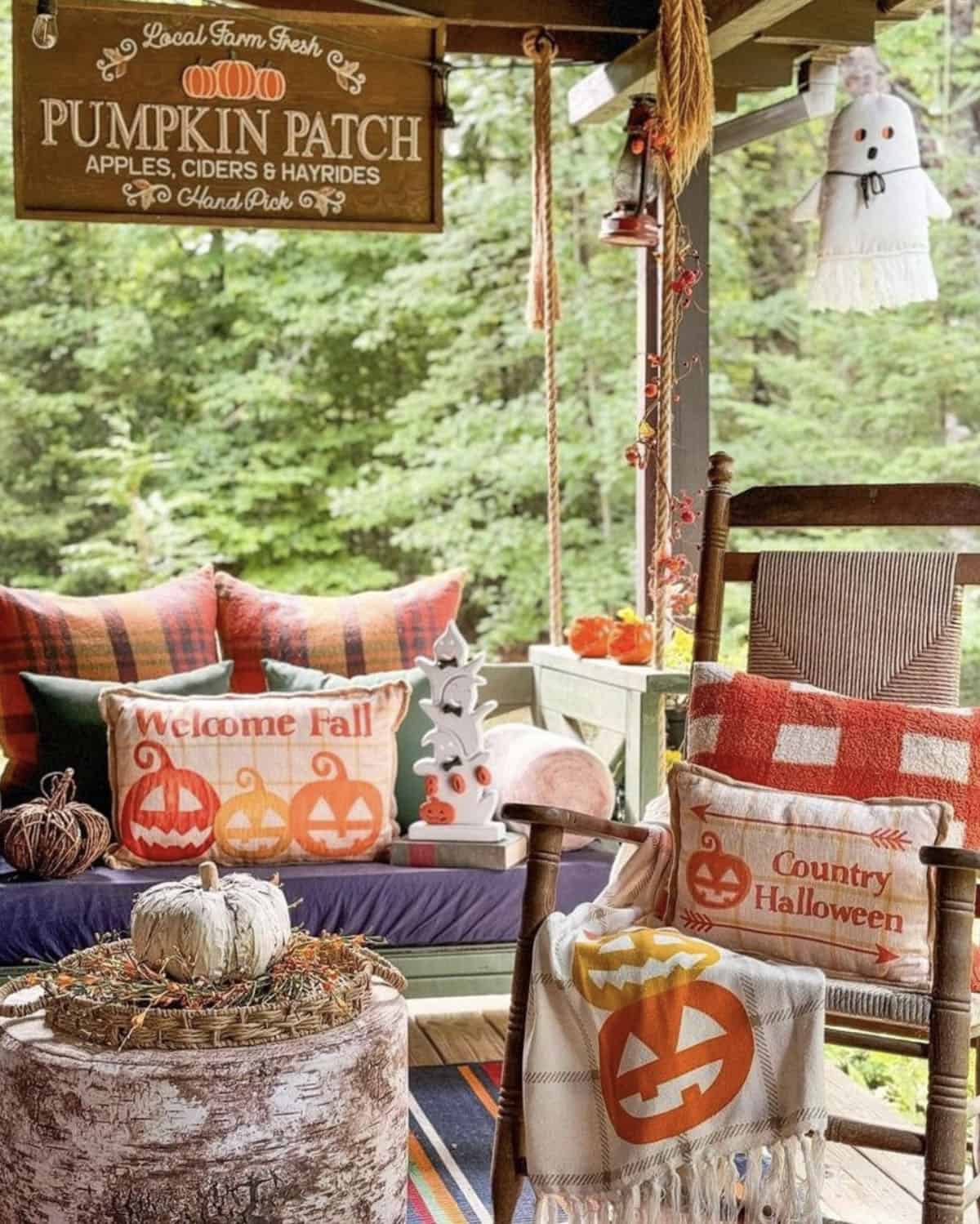 backyard porch with a hanging swing and fall decorations