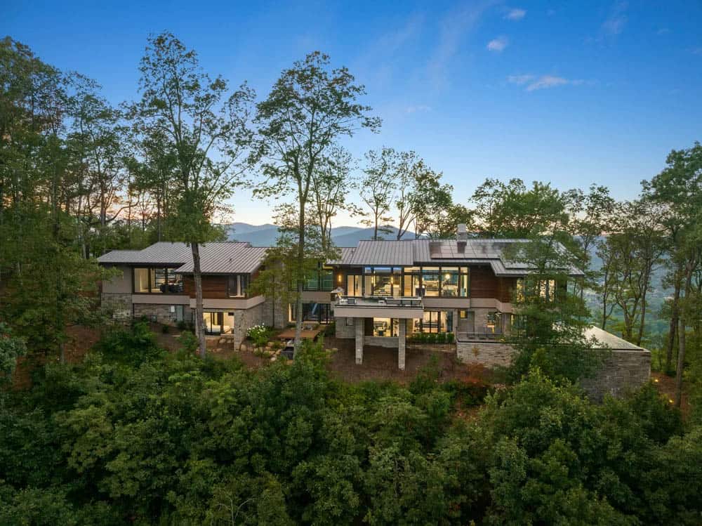 modern mountain home exterior surrounded by trees