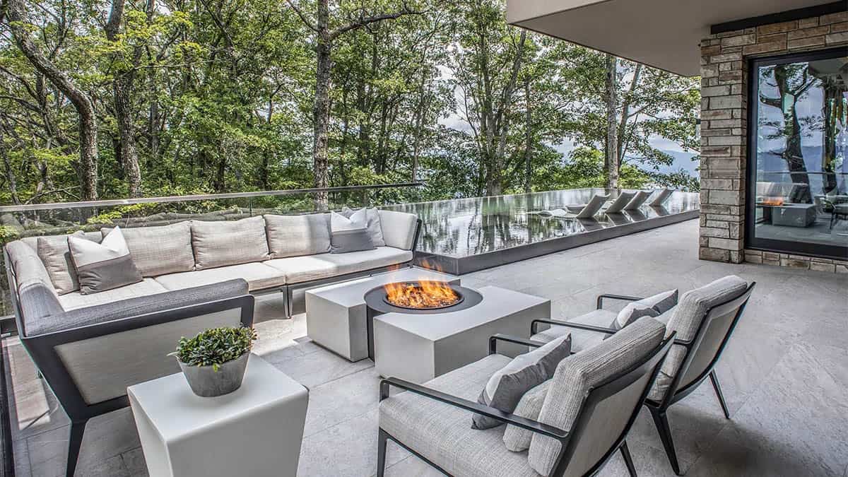 modern mountain home exterior patio with a fire pit