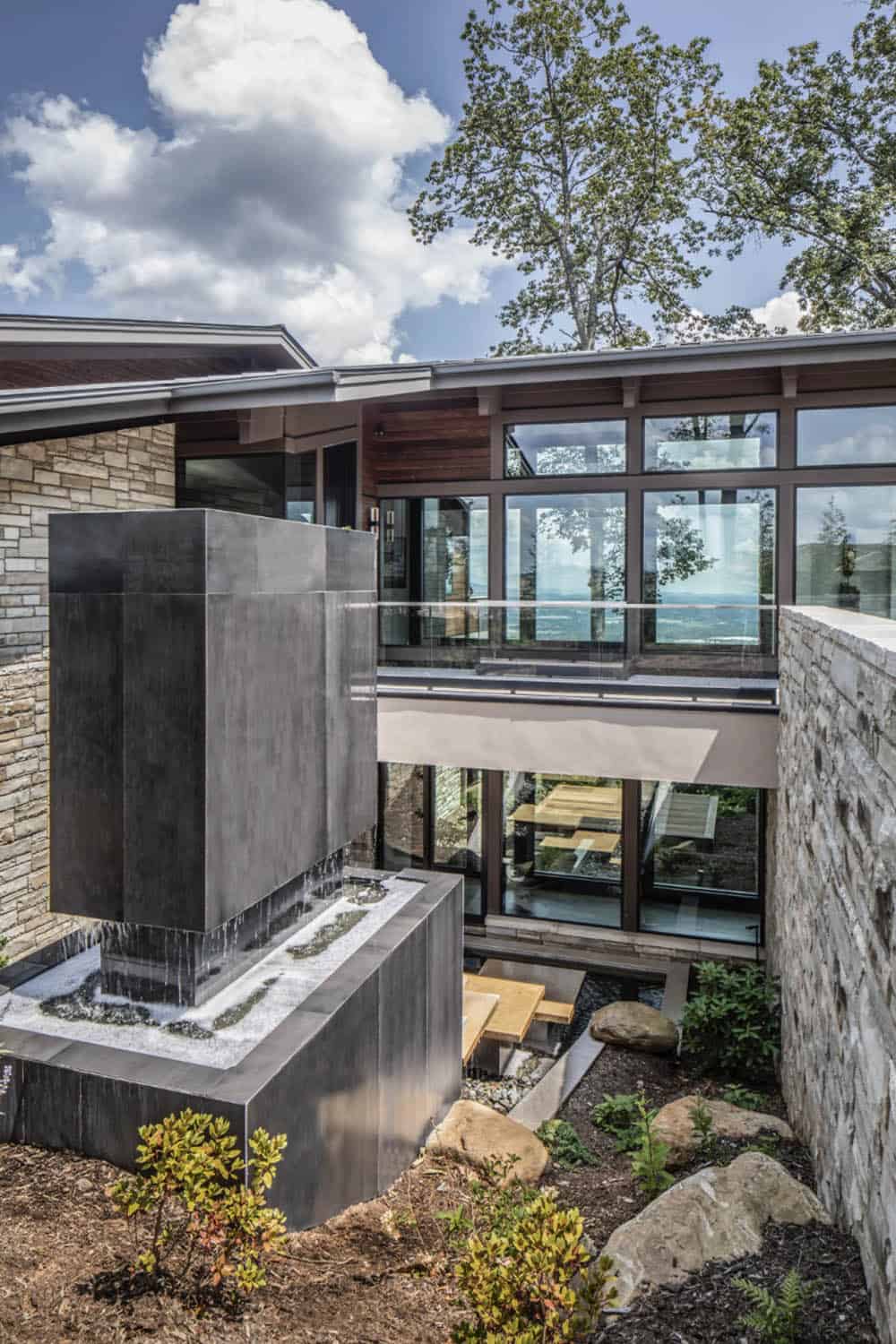 modern mountain home exterior with a water feature