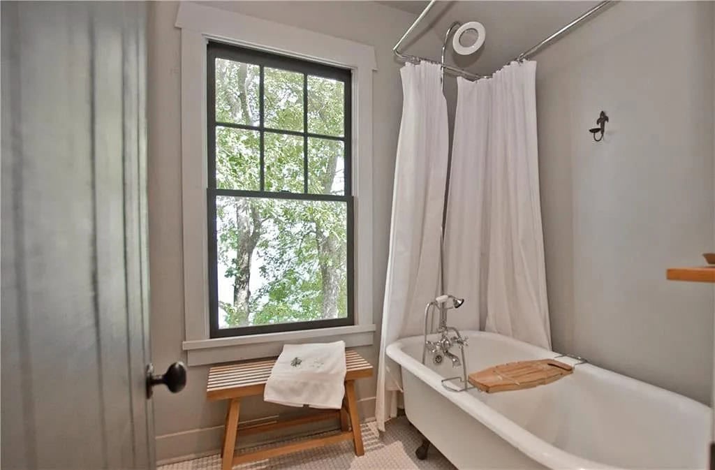 transitional style bathroom with a freestanding tub and shower combo