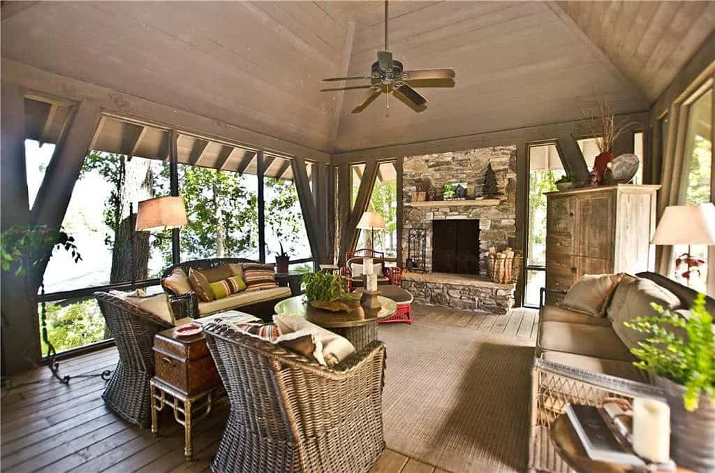 transitional style screened porch with a fireplace