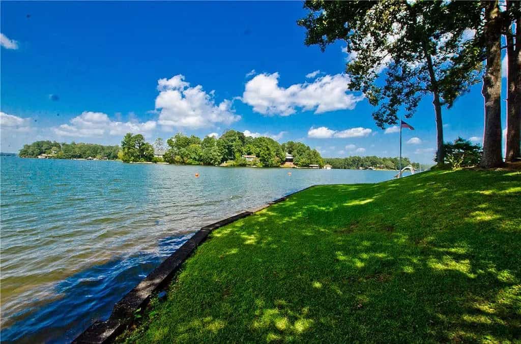rustic lake house exterior landscaping with a lake view